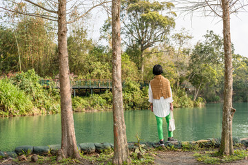 traveling Asian woman stand near the lake