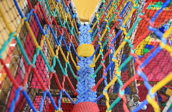 Colorful Walk bridge rope with side rope protection on indoor playground.