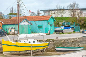 Fototapeta na wymiar Picturesque landscape with boats and fishermen's huts