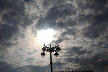 Street lamp on a background of a cloudy sunset sky