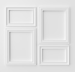 White frames for photo on white wall with shadows