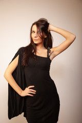 Fototapeta premium Beautiful brunette girl posing for photo at the studio