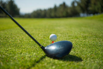 close up of a golf ball before it will be hitting by the drive