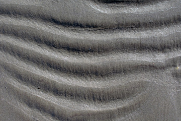 Wavy beach sand background, horizontal waves, close up