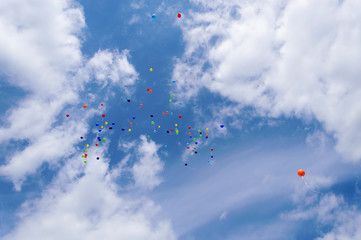 Balloons flying to the blue sky