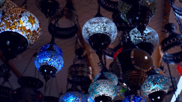 Camera moving throught traditional turkish lamps at night time