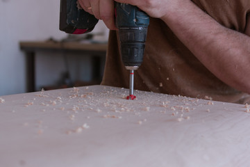 Man drilling the plywood