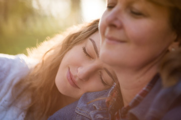 Love - senior mother with her teen daughter outdoors