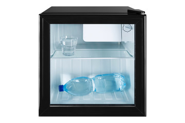 small fridge bar with a transparent glass door, inside the bottle and a glass full of water, the concept of summer and cooling