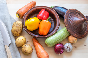 Tajine and raw ingredients for cooking vegetarian vegetable tagine