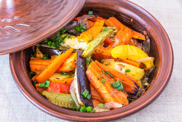 Vegetarian dish, homemade tajine or tagine with potatoes, eggplants, zucchini and pepper, close-up...