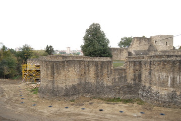 Fototapeta premium An old medieval fortress. Restoration of the walls of the fortress, excavation.