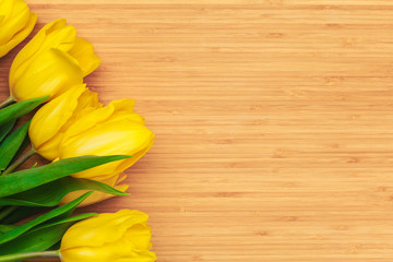 Womens day. Tulips bouquet on wooden planks background, copy space, top view