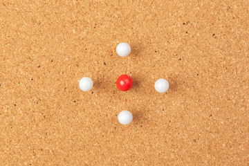 Group of thumbtacks pinned on corkboard