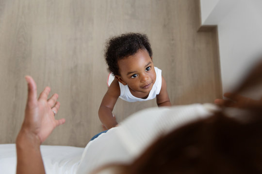 Toddler looking up at his mother