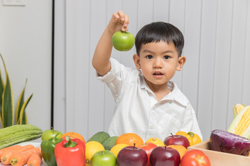 Fototapeta premium Healthy and nutrition concept. Kid learning about nutrition with doctor to choose eating fresh fruits and vegetables.