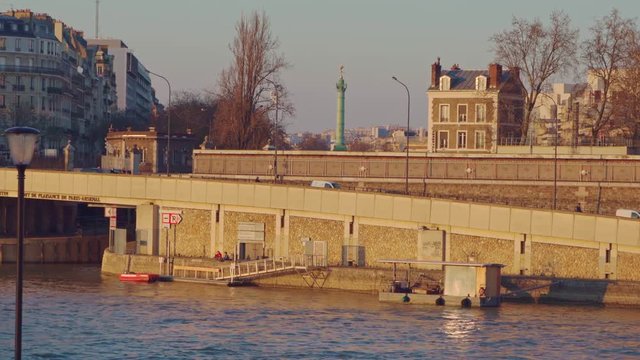 The riverside of the river Seine and the Jupiter Column at la Place de Bastille at sunset in Paris, France