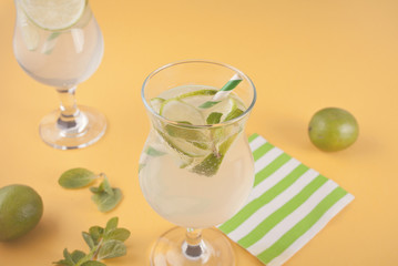 Lemonade or mojito cocktail with lemon and mint, cold refreshing drink or beverage