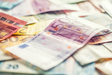 Several hundred euro banknotes stacked by value