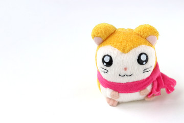 Children's soft toy mouse in a pink scarf is located on a white background