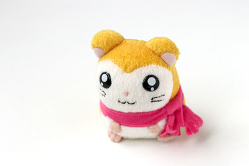 Children's soft toy mouse in a pink scarf is located on a white background