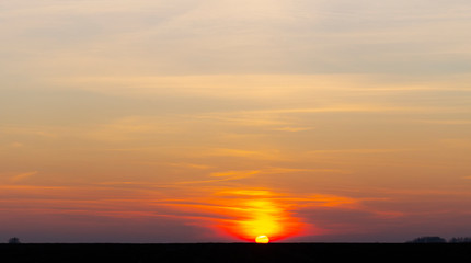 Landscape with bloody sunset. The terrain in southern Europe. Tragic gloomy sky. Purple-magenta clouds.
