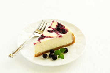 Homemade cheesecake with black currant jelly.