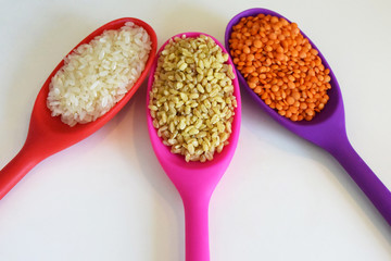 Rice, lentil, bulgur wheat in spoons