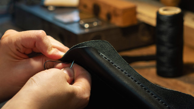 Leather handbag craftsman at work in a workshop