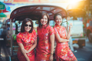 group of asian woman wearing chinese tradition clothes toothy smiling face happiness emotion and hand sign i love you