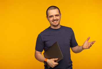 Startuper man freelancer or developer smiling and holding laptop