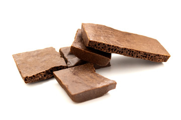 pieces of porous chocolate on a white background, isolate 