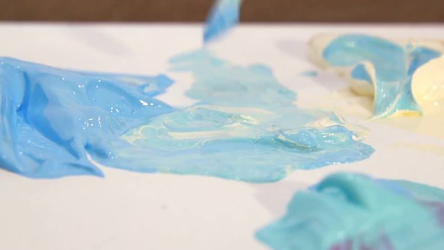 Artist mixes the paint on the Board