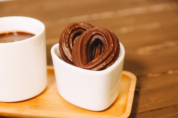 small spanish chocolate fritters served on a wooden table