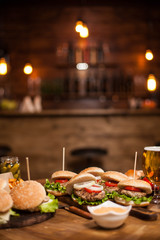 Delicious burgers and cheesburgers on a table