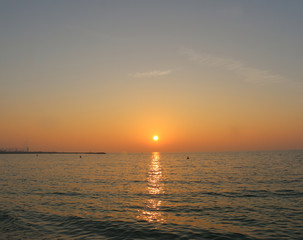 Fototapeta premium Scenic sunset and natural dramatic cloudy sky and sunbeam view over Dubai, United Arab Emirates