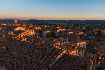 Obraz premium A sweeping view of the rooftops of Gubbio at sunset taken from the main Piazza Grande in the town centre