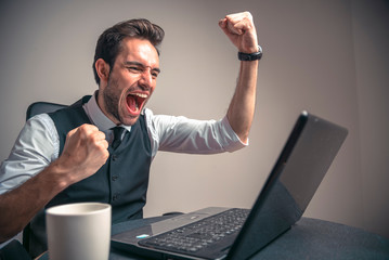 Excited business man receiving winning news, celebrating and feeling victorious