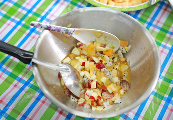 Cooking fruits salad in stainless bowl.