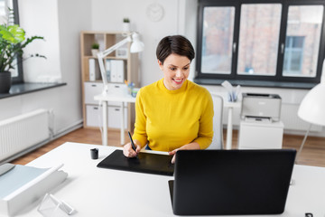 business, design and technology concept - creative woman or graphic designer with computer and pen tablet working at office