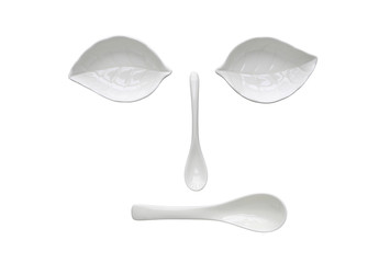 Funny face from white ceramic leaf bowl and spoon.