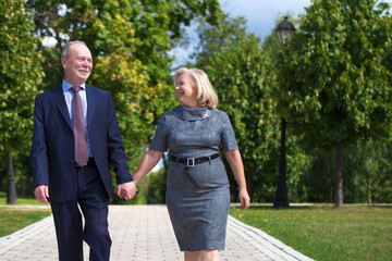 Fototapeta premium Senior couple walking in summer in park