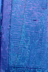 Obraz premium Old wooden background with remains of pieces of scraps of old paint on wood. Texture of an old tree, vintage wood background peeling paint. old blue board with cracked paint