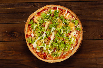 Appetizing pizza on a wooden background