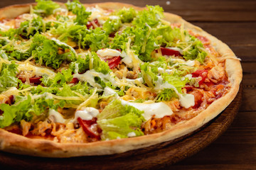 Appetizing pizza on a wooden background