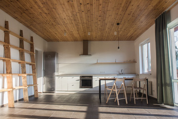 Cooking food on modern kitchen with furniture in grey color and wooden tabletop,Stylish kitchen...