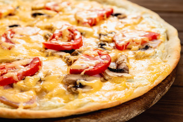Appetizing pizza on a wooden background