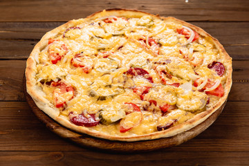 Appetizing pizza on a wooden background