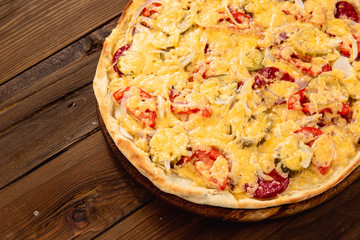 Appetizing pizza on a wooden background