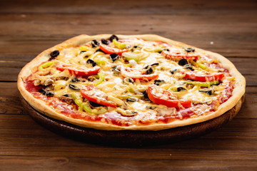 Appetizing pizza on a wooden background